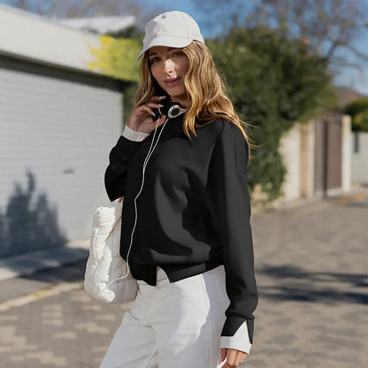 Black layered sweatshirt styled with white trousers