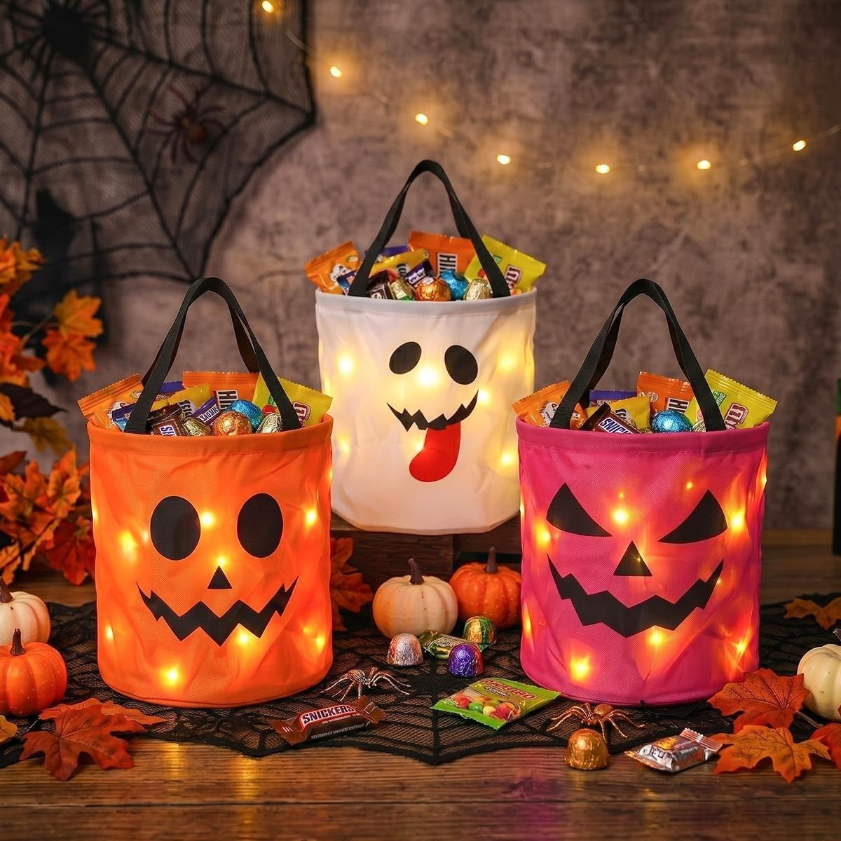 Orange, white ghost and pink LED candy buckets filled with candy