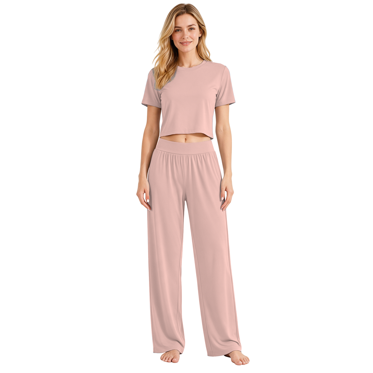 Pink colourway — AI-generated studio image of an adult model wearing the two-piece pyjama set (short cropped crew-neck tee with exposed midriff, wide elastic high-waist wide-leg trousers)